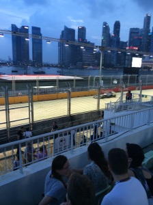 Formula One Car racing past the Marina Bay Grandstand